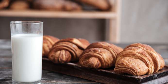 image-of-croissants-on-dark-wooden-table-with-milk-at-bakery-SBI-303743417-min-scaled.jpg